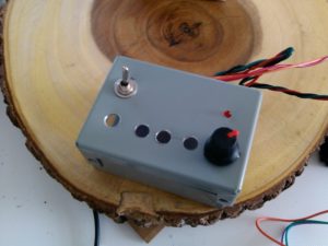 The metal control box with holes for the buttons